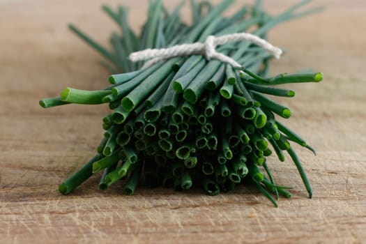 Chives on a wooden surface