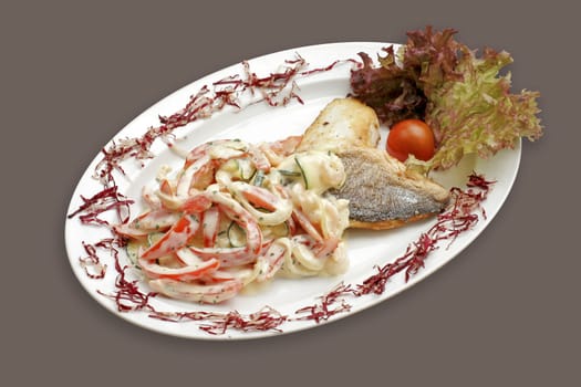 Grilled fish with vegetables and sauce.