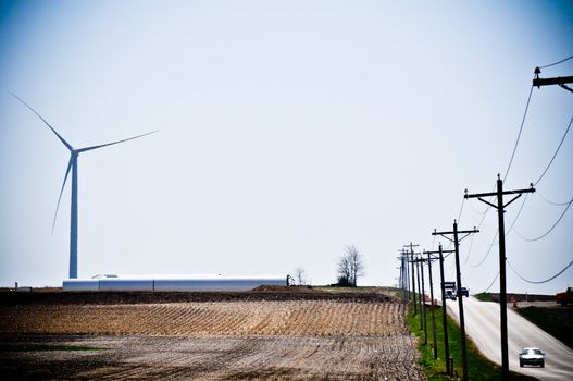 Cars drive by the turbine