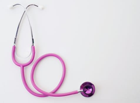 great image of pink stethoscope on white