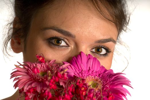 Girl smelling flowers isolated on white