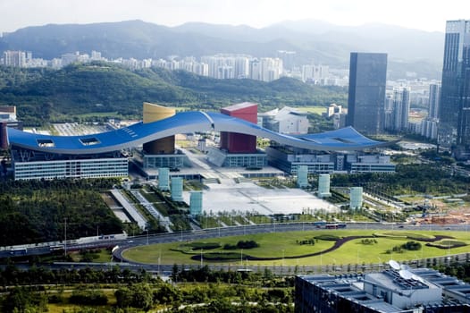Chinese metropolis - Shenzhen, modern city full of skyscrapers, office buildings, hotels and residential areas. Civic center with special - wave shape roof.