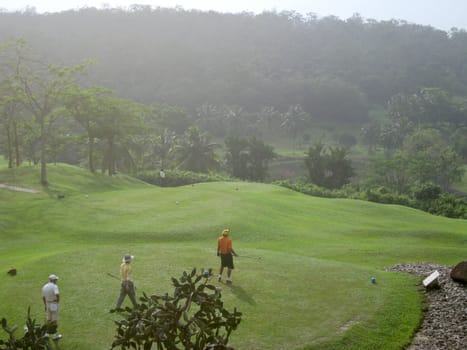 a few of men are playing golf 