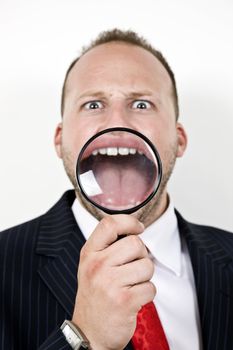 man with open mouth with magnifier glass
