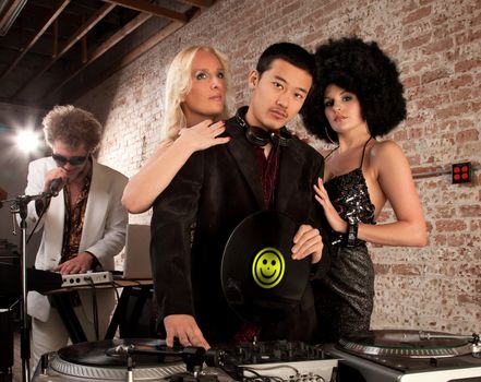 Desirable young DJ with two female admirers