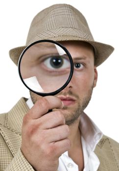 man holding magnifier close to eye on isolated background
