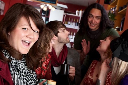 Woman in front of diverse friends in a coffee house