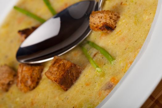 potato soup with croutons and chive strands