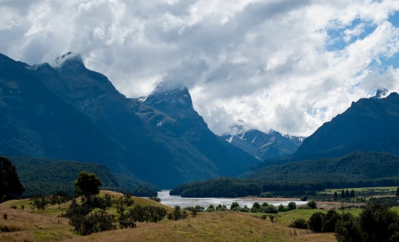 Rolling countryside valley in New Zealand with folded hills and mountains