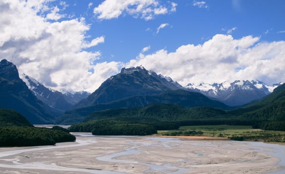 Rolling countryside valley in New Zealand with folded hills and mountains