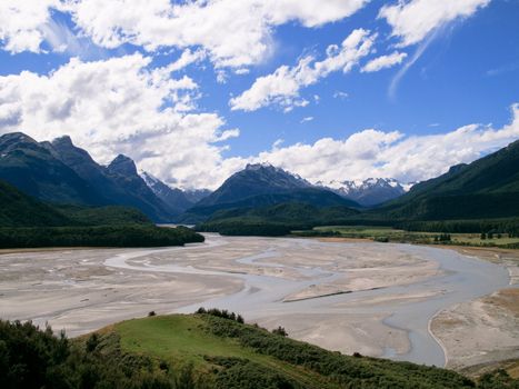 Rolling countryside valley in New Zealand with folded hills and mountains