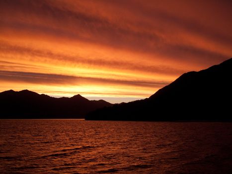 Brilliant sunset over the sea near Queenstown in New Zealand