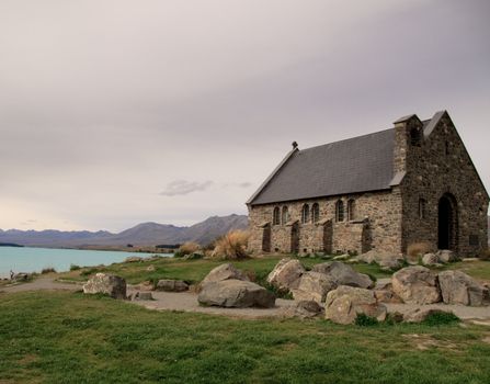 Lake Tekapo in New Zealand with an old stone chapel on the lake's edge
