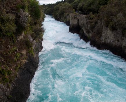 Strong blue water streams from Huka waterfall in New Zealand