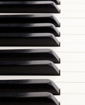 Macro image of quality piano keys from grand piano, with focus receding both backwards and forwards