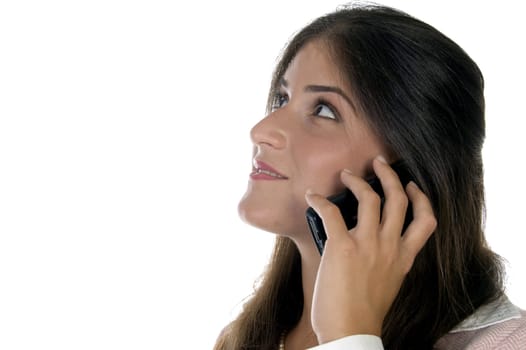 female holding mobile and looking upward on an isolated background