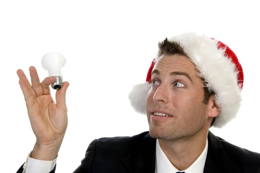 businessman holding bulb and wearing santacap  on an isolated white background