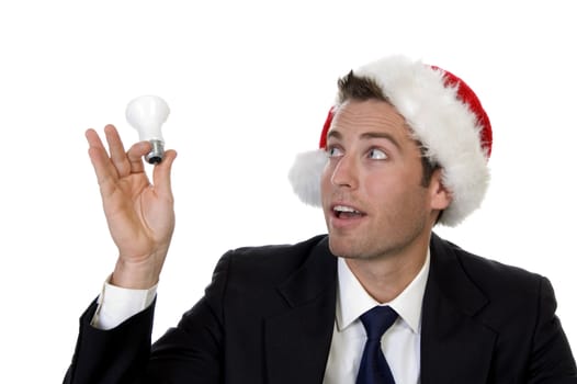 businessman looking bulb and wearing santacap with white background