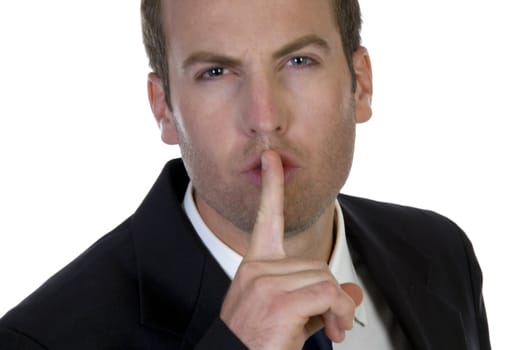 portrait of businessman with his finger on his lips on white background