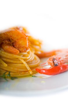 italian spaghetti pasta and fresh spicy shrimps sauce over white