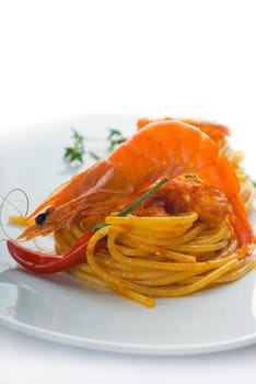 italian spaghetti pasta and fresh spicy shrimps sauce over white