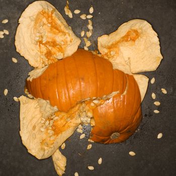 Pumpkin smashed on concrete floor.