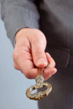 Businessman handing and giving a key to success