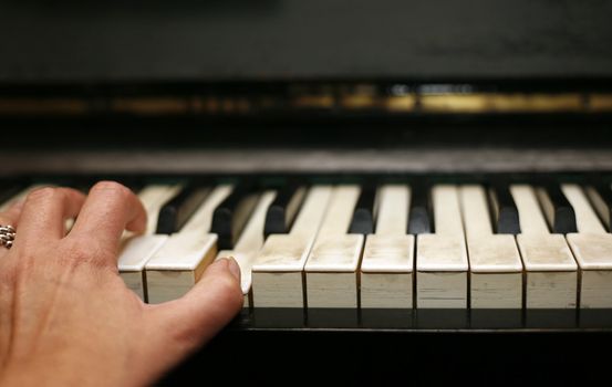 The image of the piano and woman's hand