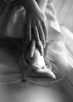 Wedding shoes on legs of the bride