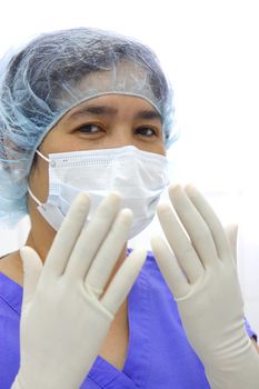 portrait of a nurse or doctor wearing sterile surgical gloves