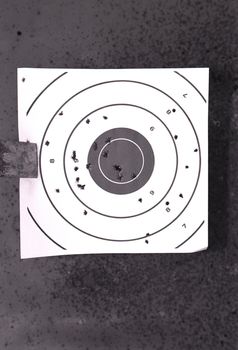 Bullseye target with bullet holes

