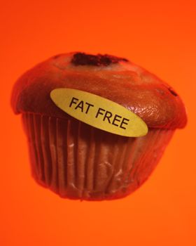 Muffin with fat free sticker on orange
