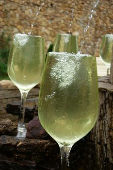 big white wine glasses pouring as fountain