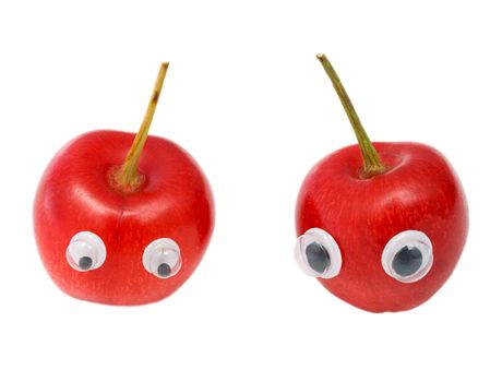 Two ripe sweet cherries with eyes on a white background