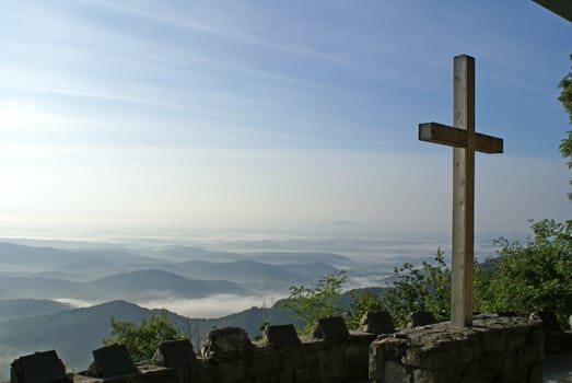 Cross overlooking the mountains in a church.         