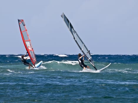Two windsurfers racing in the Mediterranean Sea