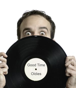 Closeup view of a young man holding an old lp record in front of his face, which says Good Time Oldies. *Text in image is done by photographer