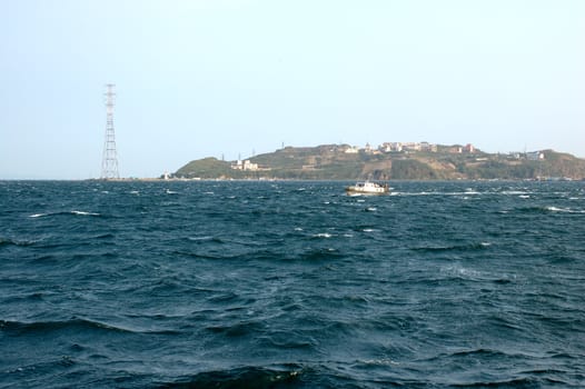 Sea scenery of Vladivostok with small cutter and storm sea.