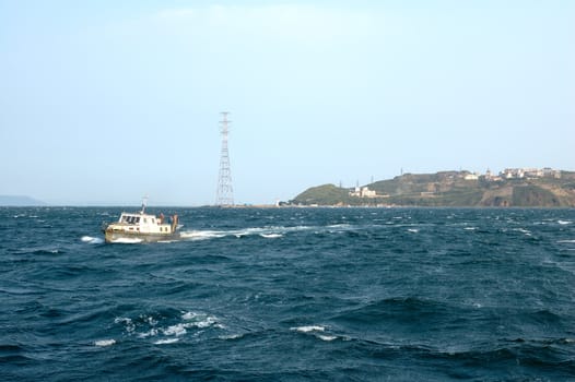 Sea scenery of Vladivostok with small cutter and storm sea.