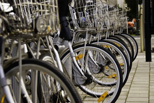 Bikes are provided to tourists and citizens for a nominal fee in the city centre of Brussels, Belgium. The bikes are an environmentally friendly means of transportation.