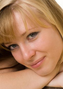 Portrait of the smiling young woman. The beautiful face close up.