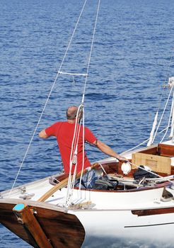 Sailor pulling rope on a boat in navigation 