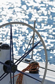 Detail of a sailboat rudder and instruments against water