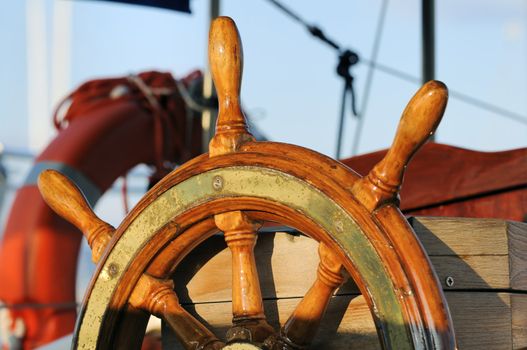 Detail of a wooden steering wheel on a vintage sailboat