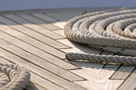 Close-up of rolled-up ropes on a boat deck