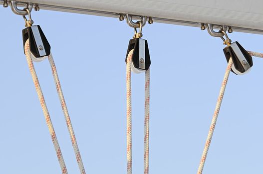 Detail of three nautical pulleys with rope