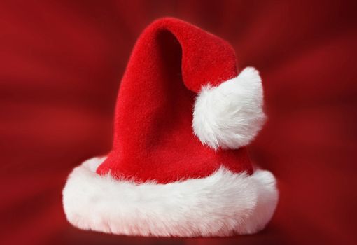 red Santa Christmas hat, red background