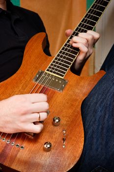 Musician playing an electric guitar cropped