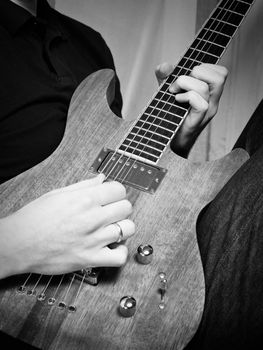 Musician playing electric guitar, black & white shot