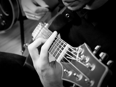 Musician playing electric guitar, shallow depth of field